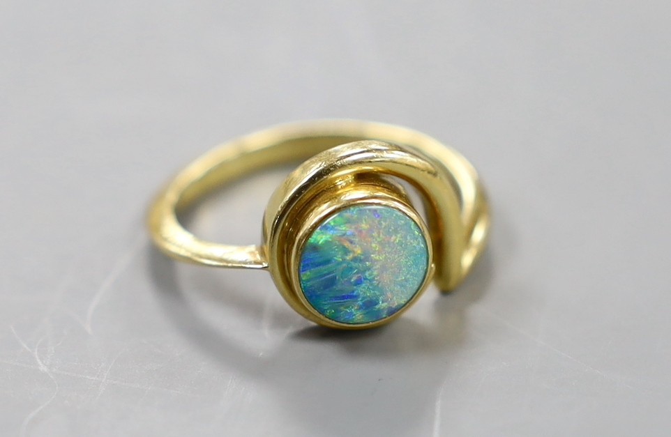 A modern 18ct gold and white opal set ring, size R, gross weight 6.2 grams.